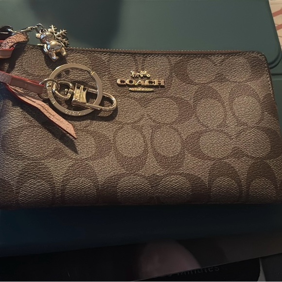 Coach Handbags - Large Corner Zip Wristlet in Signature Canvas.